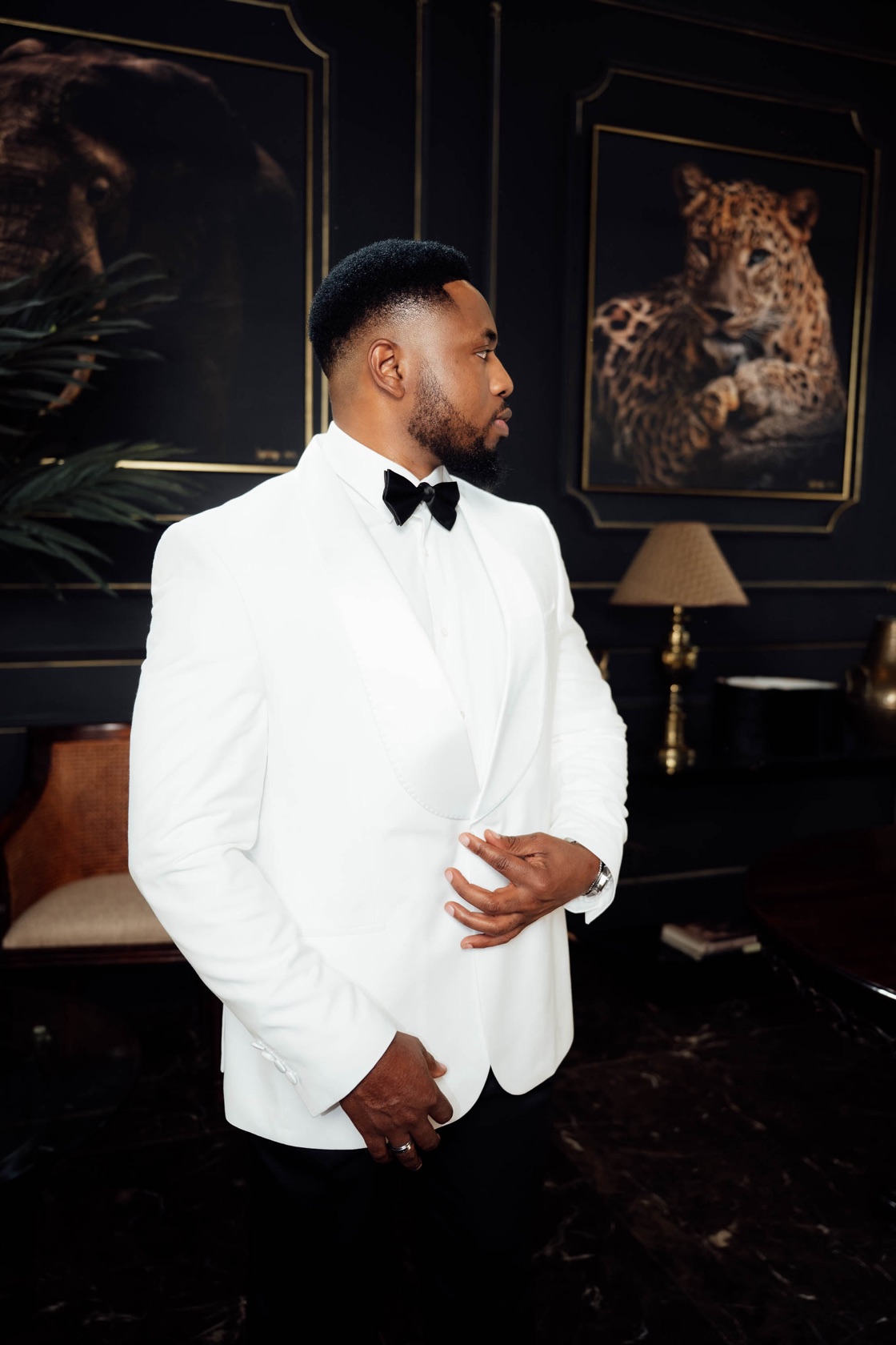 Manuchie in a white tuxedo